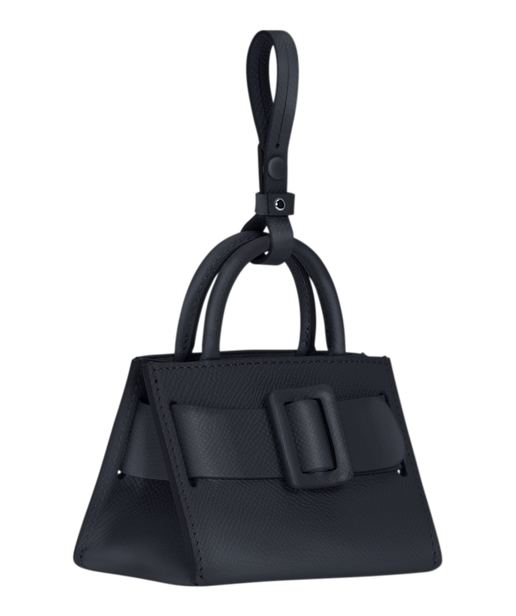 Miniature structured blue handbag charm with a leather buckle on the front, carry strap, and twin handles. Made with grained calfskin leather.