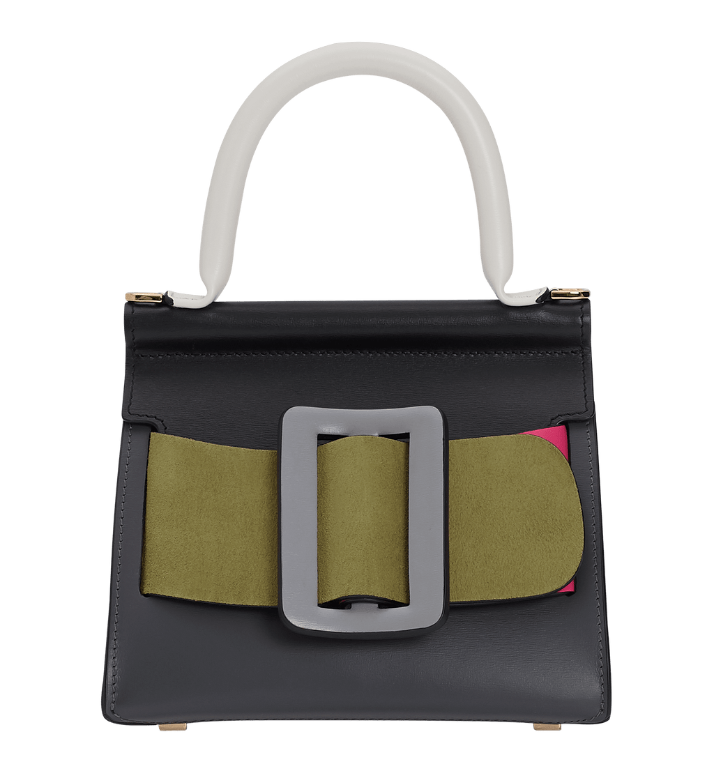 Smooth leather, structured handbag with an oversized leather buckle, single carry handle, carry strap, and front flap closure.