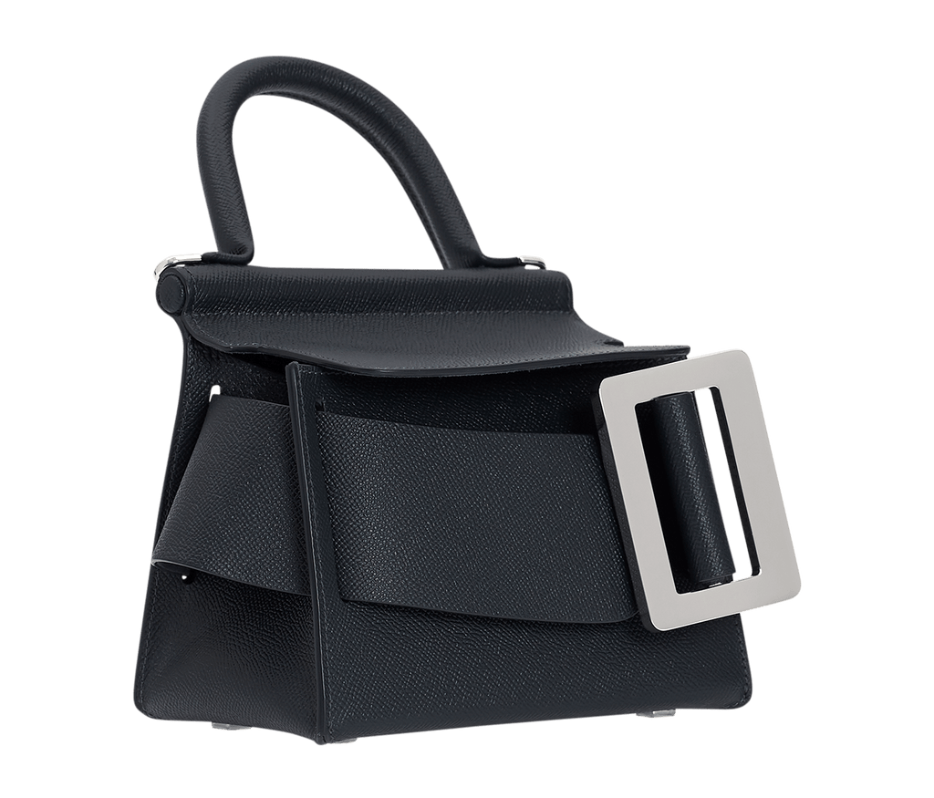 Blue, grained leather, structured handbag with an oversized silver buckle, single carry handle, carry strap, and front flap closure.