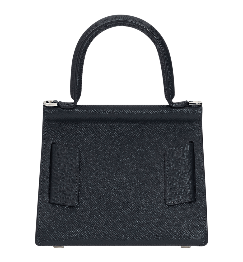 Blue, grained leather, structured handbag with an oversized silver buckle, single carry handle, carry strap, and front flap closure.