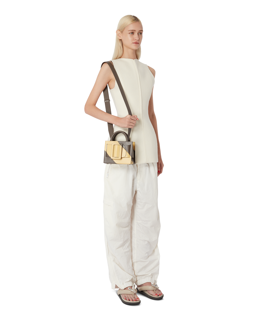 Falcon polenta yellow BOYY BOBBY 18 handbag crafted from palmellato calfskin leather with suede lining. Features a structured silhouette, detachable shoulder strap, and an oversized belt and buckle closure on model