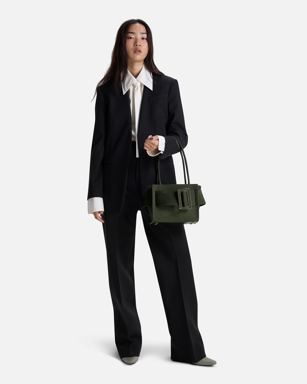 Sage Green BOYY BOBBY soft 23 luxury handbag made of suede calfskin leather with fine-grain calfskin lining. Features a relaxed, modern silhouette, extended over the shoulder handles with an oversized belt, buckle, and zipper closure on model