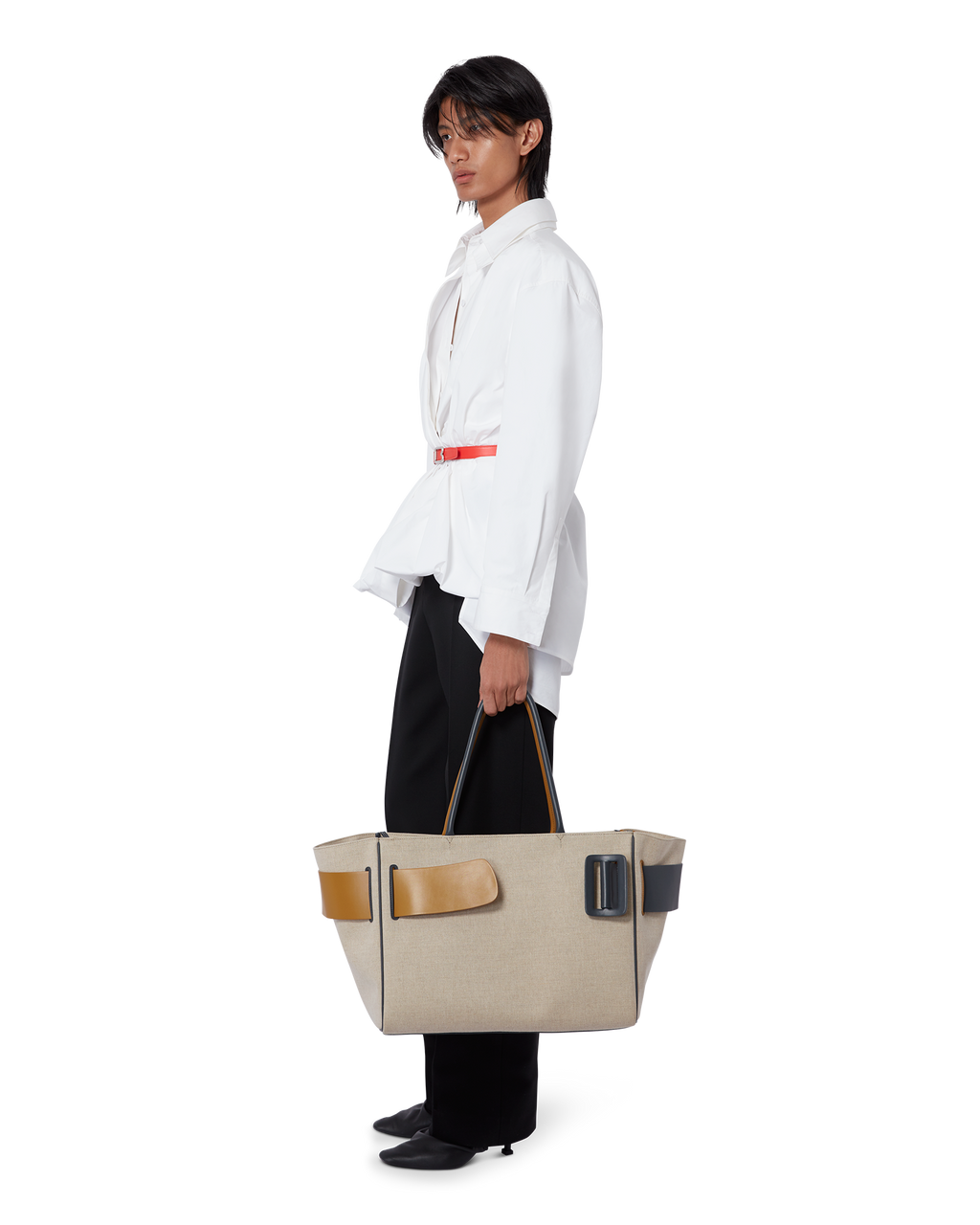 Color Block BOYY BOBBY Weekend soft luxury handbag made of canvas. Features a relaxed, modern silhouette, extended over the shoulder handles with an oversized belt, buckle, and zipper closure on model