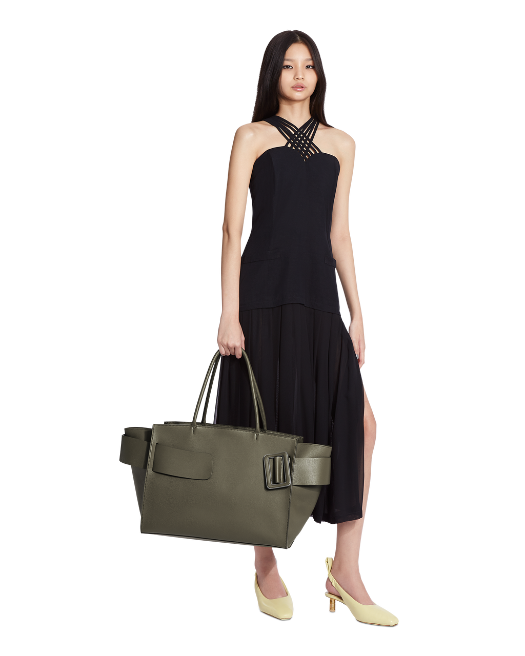 Hojicha BOYY BOBBY Weekend soft luxury handbag made of calfskin leather with fine-grain calfskin lining. Features a relaxed, modern silhouette, extended over the shoulder handles with an oversized belt, buckle, and zipper closure on model