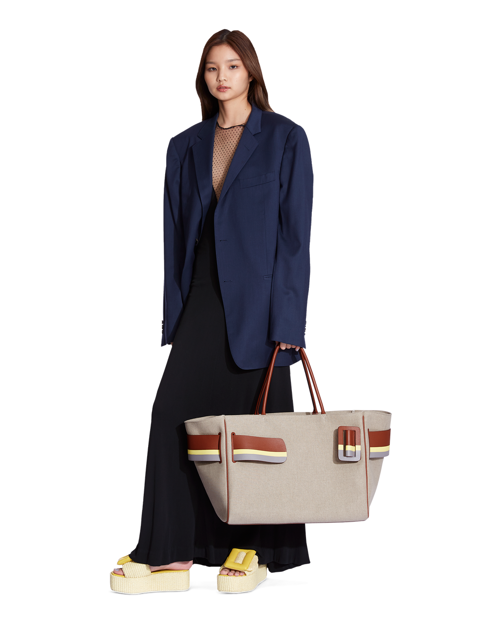 Color Block BOYY BOBBY Weekend soft luxury handbag made of canvas. Features a relaxed, modern silhouette, extended over the shoulder handles with an oversized belt, buckle, and zipper closure on model        