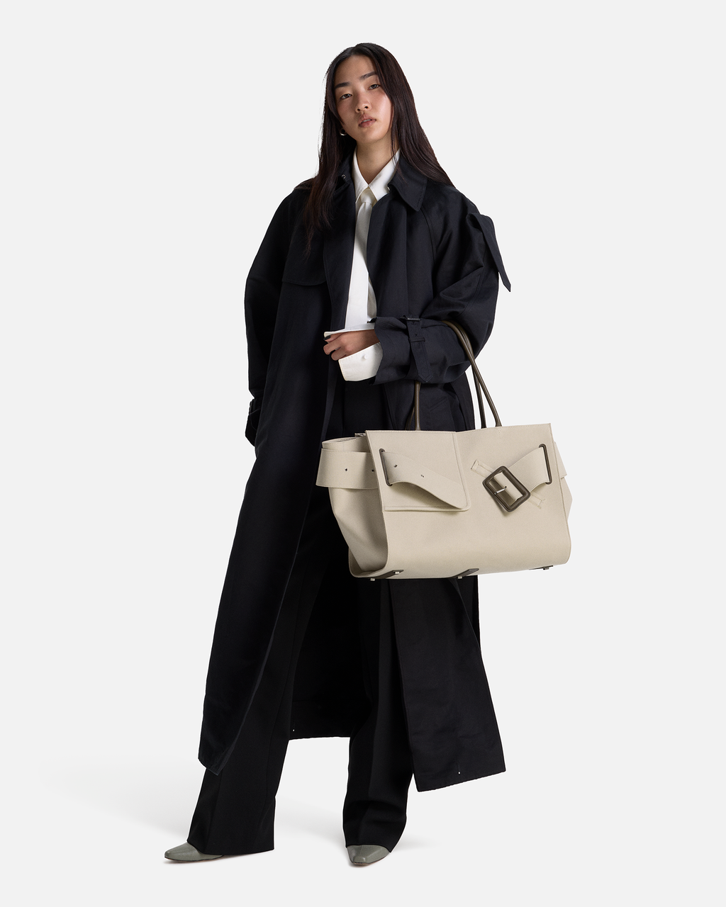 Beige BOYY BOBBY Weekend Soft luxury handbag made of cotton, polyurethane and calfskin leather. Features a relaxed, modern silhouette, extended over the shoulder handles with an oversized belt, buckle, and zipper closure on model