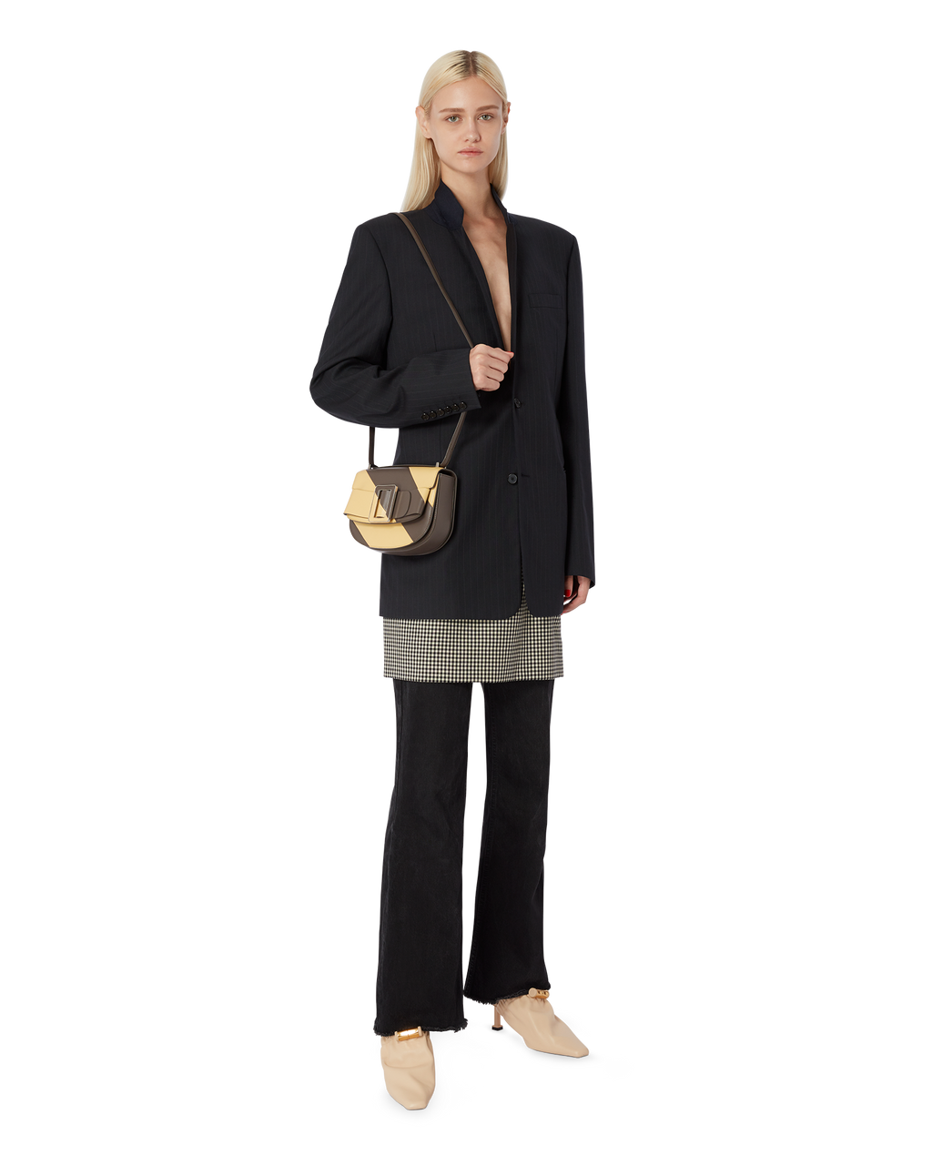 Falcon polenta brown yellow BOYY SADDLE bag made of palmellato calfskin leather, with a structured saddle-shaped silhouette, flap closure, adjustable shoulder-to-crossbody strap, and signature oversized buckle on model