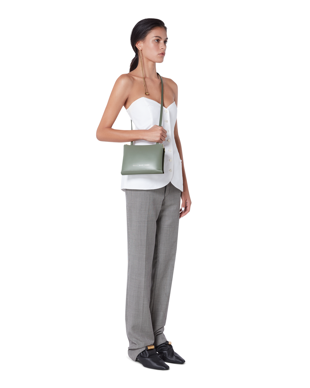 Celadon green BOYY DUPLÉ shoulder/crossbody travel bag in boxcalf leather, polenta yellow goatskin lining, two compartments with gold and silver zippers on model