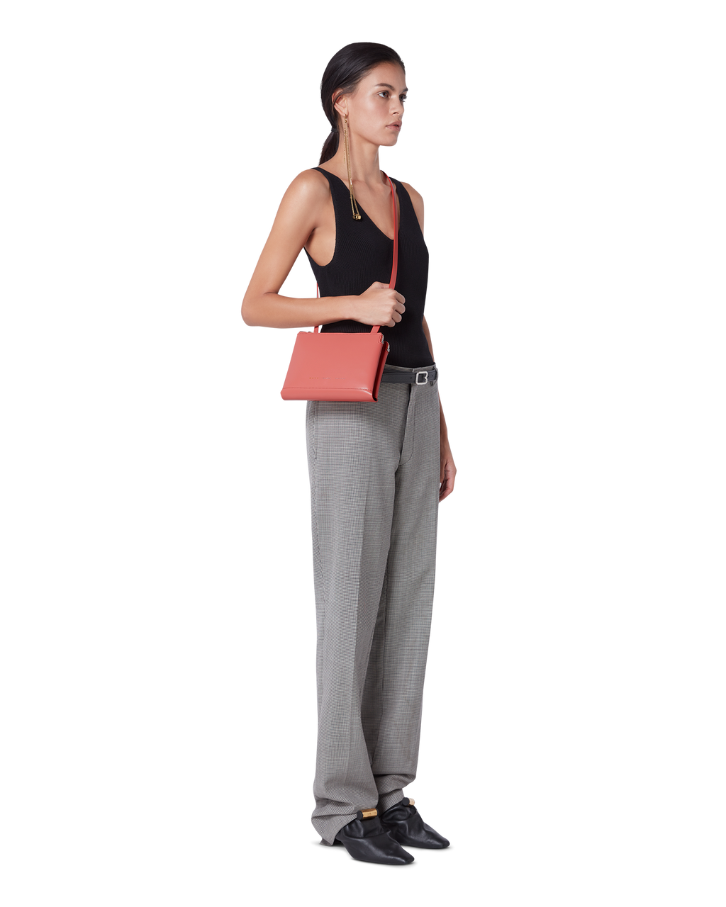 Coral pink BOYY DUPLÉ shoulder/crossbody travel bag in boxcalf leather, ice grey goatskin lining, two compartments with gold and silver zippers on model