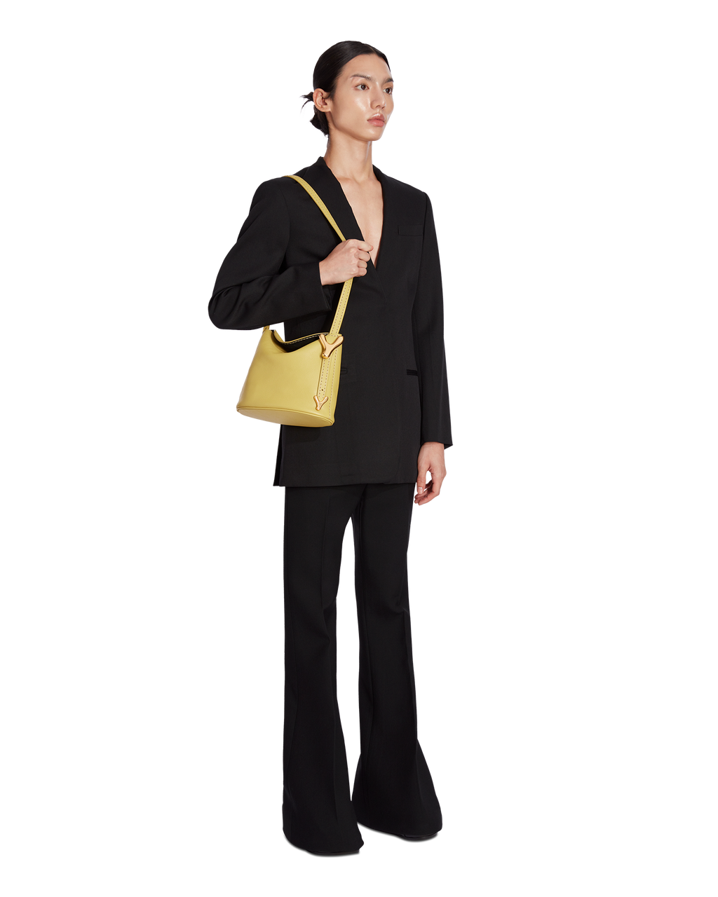 Bamboo yellow BOYY YY SAC made of supple pebbled calfskin with matte finish, slouchy hobo silhouette, featuring a flap closure with signature brass Y hardware and an adjustable shoulder-to-crossbody strap on model