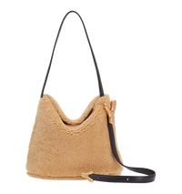 Cream BOYY YY SAC made of shearling with calfskin suede lining, slouchy hobo silhouette, featuring a flap closure with signature brass Y hardware and an adjustable shoulder-to-crossbody strap