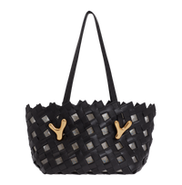 Black BOYY YY West 26 woven tote made of woven calfskin leather, with a rectangular silhouette, featuring signature brass Y hardware on both sides and adjustable shoulder handles