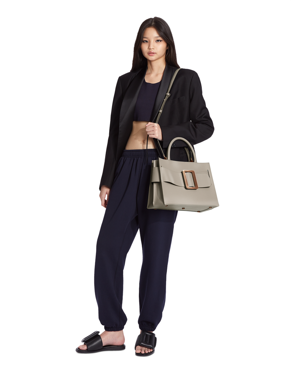 Tortora BOYY BOBBY 32 Power Bag handbag crafted from palmellato calfskin leather with suede lining. Features a structured silhouette, detachable shoulder strap, and an oversized belt and buckle closure on model